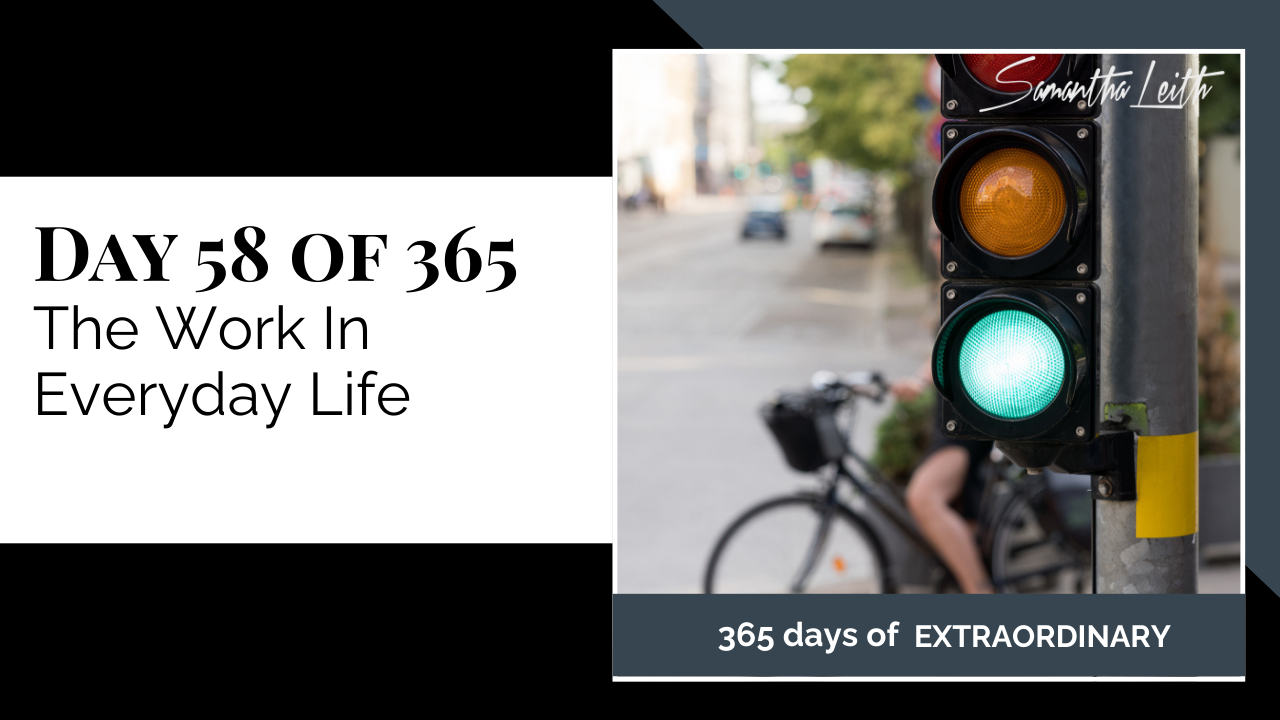 Thumbnail graphic for the topic, 'The Work In Everyday Life.' The image features a traffic light with the green light illuminated, and a blurry background showing a cyclist and cars, symbolizing taking action, moving forward, and incorporating self-improvement into daily routines.