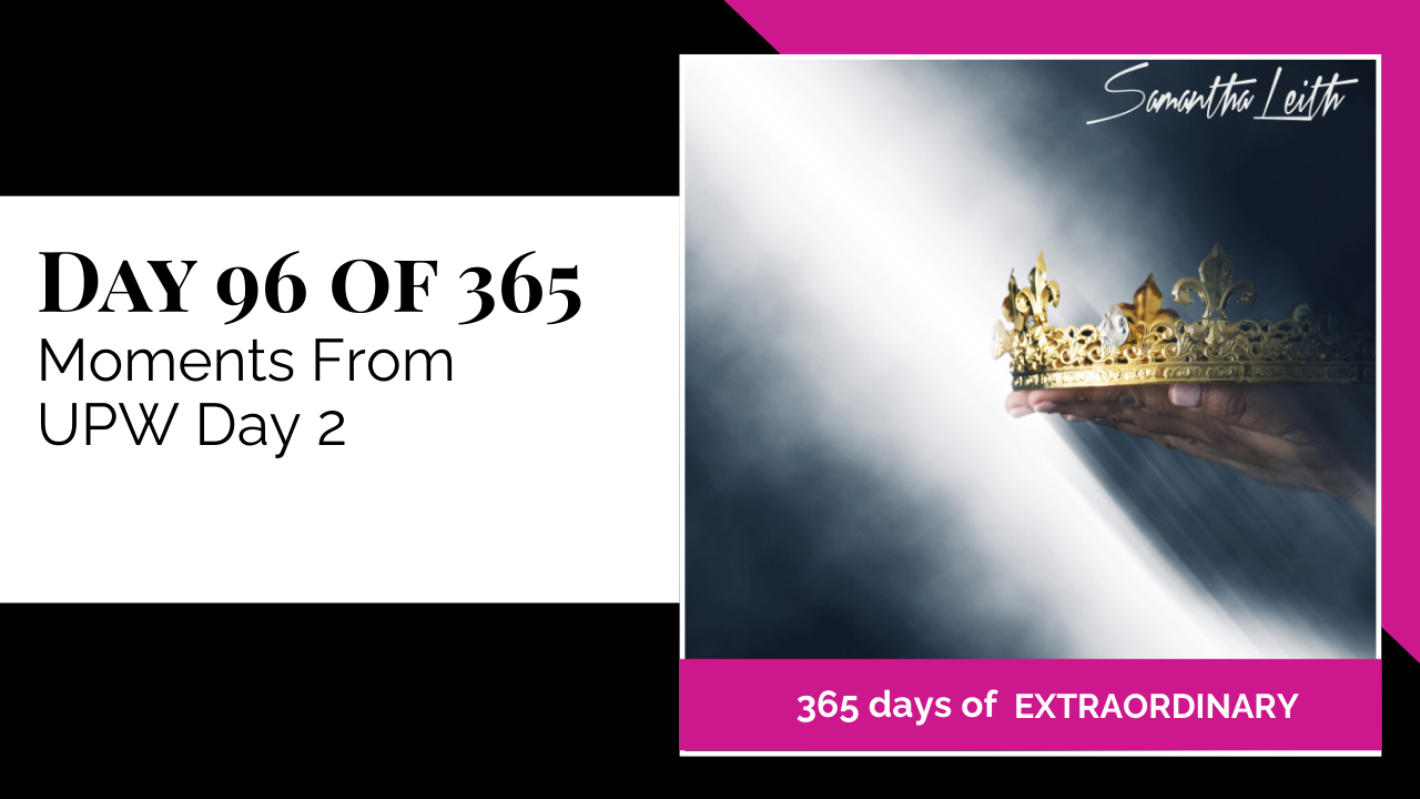 Blog image for Day 96 of Sam Leith's '365 Days of Extraordinary' series, showing a hand presenting a golden crown in a bright spotlight beam, representing empowerment and peak moments from UPW Day 2.