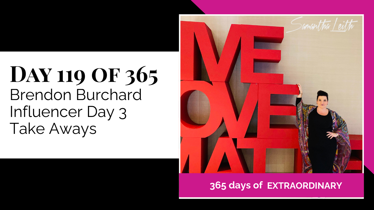 Blog image for Day 119 of Sam Leith's '365 Days of Extraordinary' series, featuring Samantha Leith posing next to a large, red "LIVE LOVE MATTER" art installation at the Brendon Burchard event.