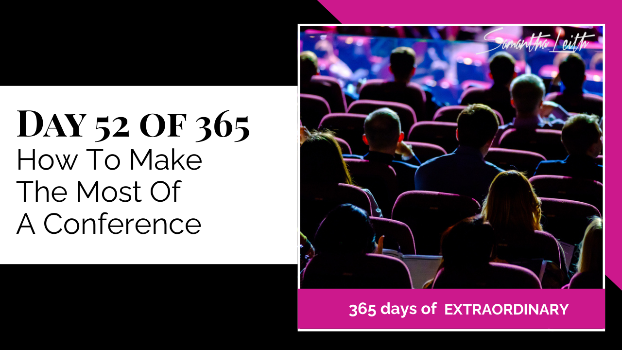 Video thumbnail featuring the text 'Day 52 of 365: How To Make The Most Of A Conference.' The image shows the backs of an audience seated in a dark, purple-lit auditorium or theater, watching a presentation or speaker on a stage. Illustrates tips for attending business or professional conferences.