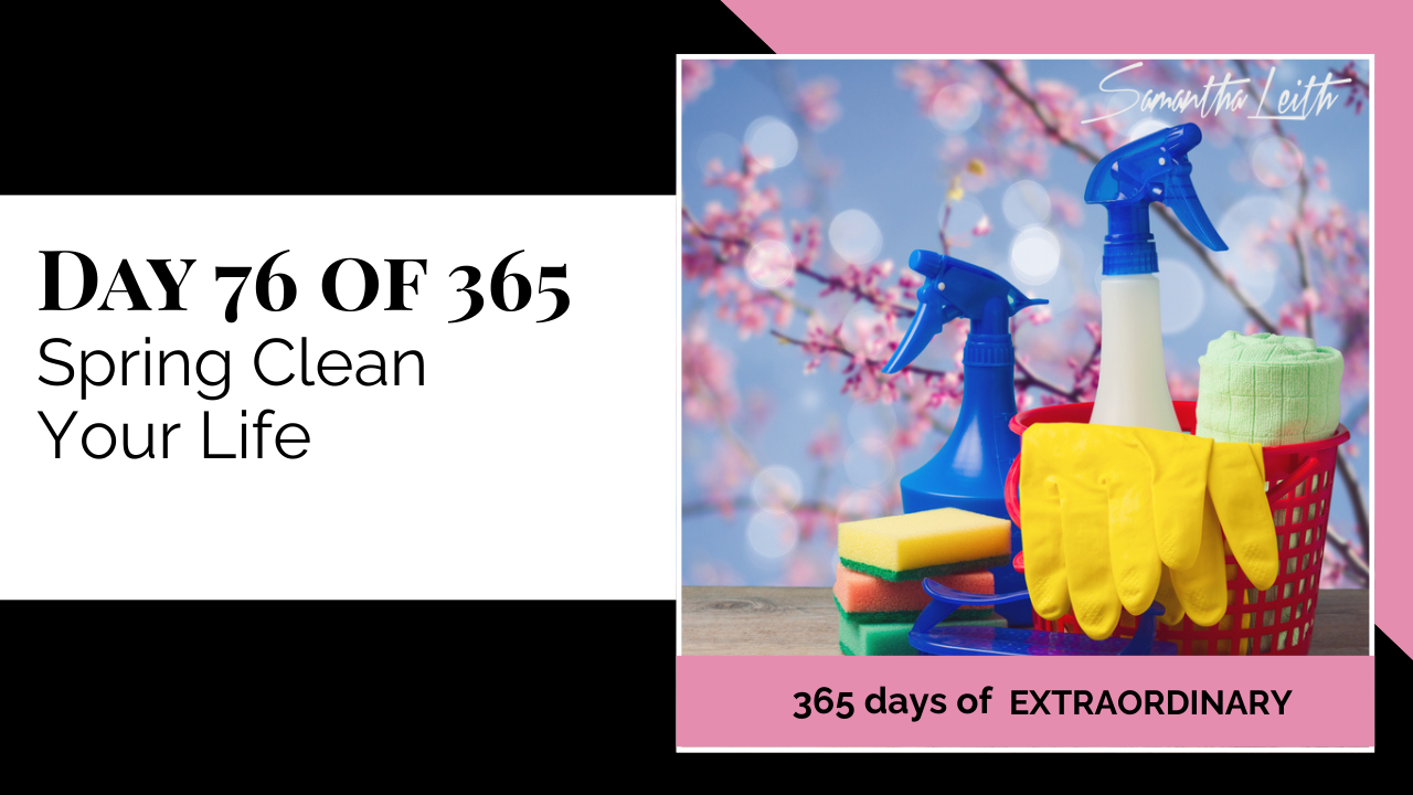 Blog thumbnail for 'Day 76 of 365: Spring Clean Your Life.' The image features household cleaning supplies (spray bottles, yellow gloves, sponges) set against a backdrop of pink spring cherry blossoms, symbolizing clearing clutter, renewal, and tidying up one's life or workspace.