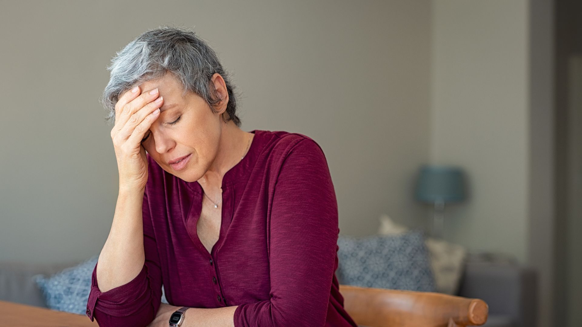 old woman having a headache