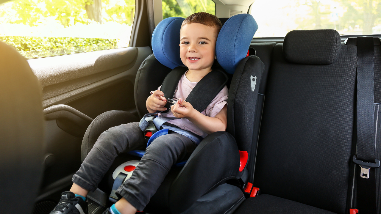 Toddler in their car seat going out after newly potty trained