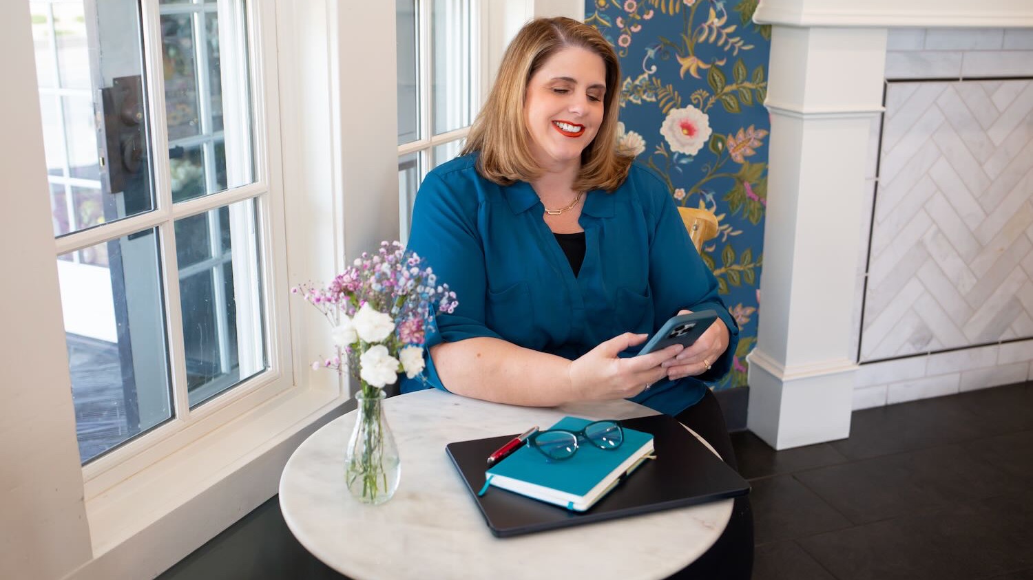 Kathy Sizemore, visibility coach, working on answer engine optimization strategy on laptop