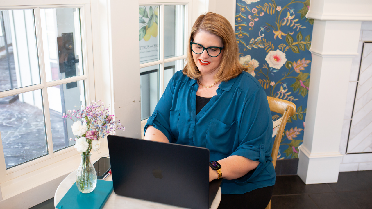 Kathy Sizemore coaching from her laptop in a bright, welcoming space, supporting women to niche down their audience with clarity and confidence