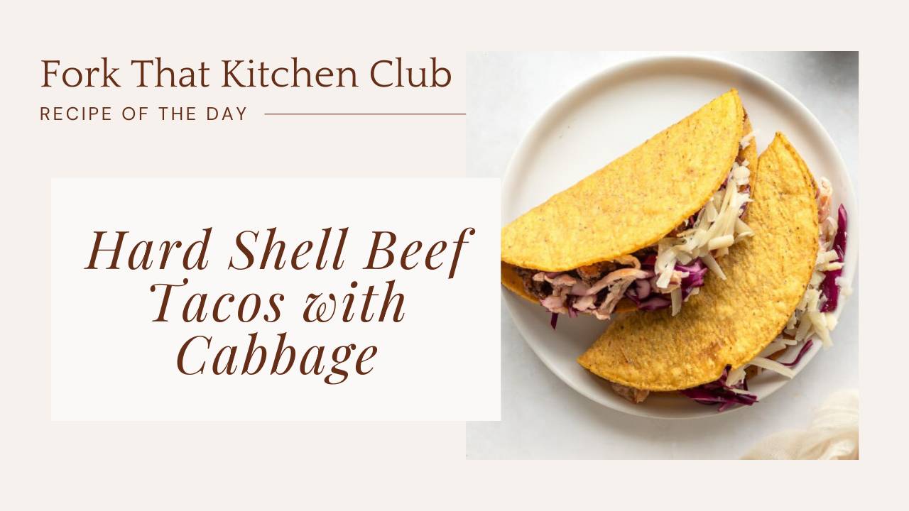 Two hard shell tacos filled with seasoned beef, cabbage slaw, and shredded cheddar cheese on a white plate