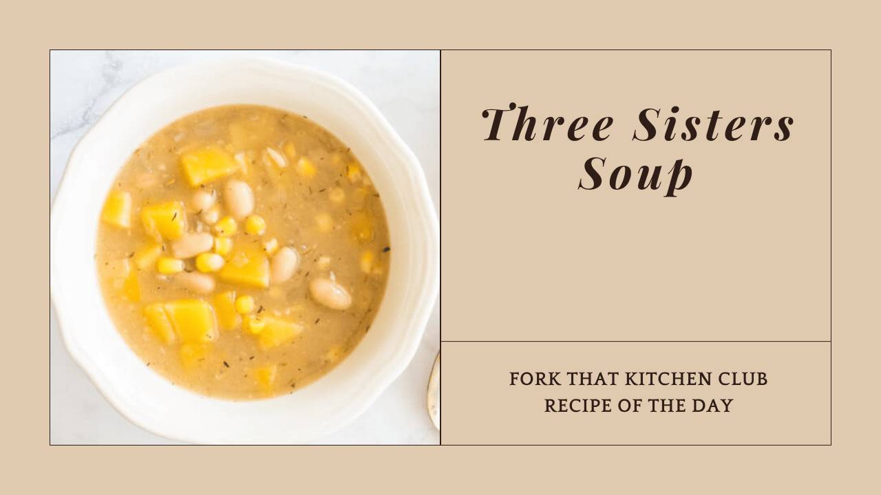 White bowl of Three Sisters Soup with butternut squash, corn, and white beans in golden broth
