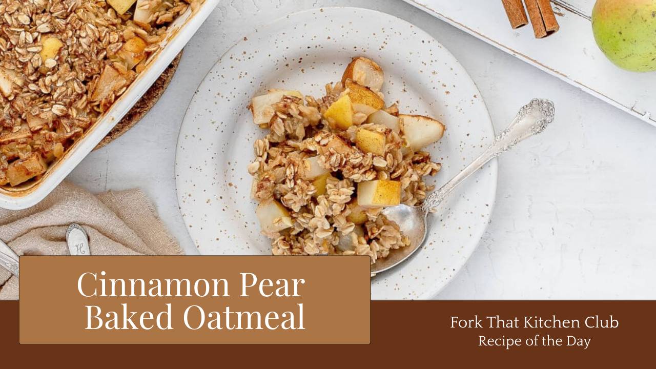 Plate of cinnamon pear baked oatmeal with a silver spoon, sliced pears visible on top, a white baking dish with more baked oatmeal to the left, and a white cutting board with a pear and cinnamon sticks to the right 