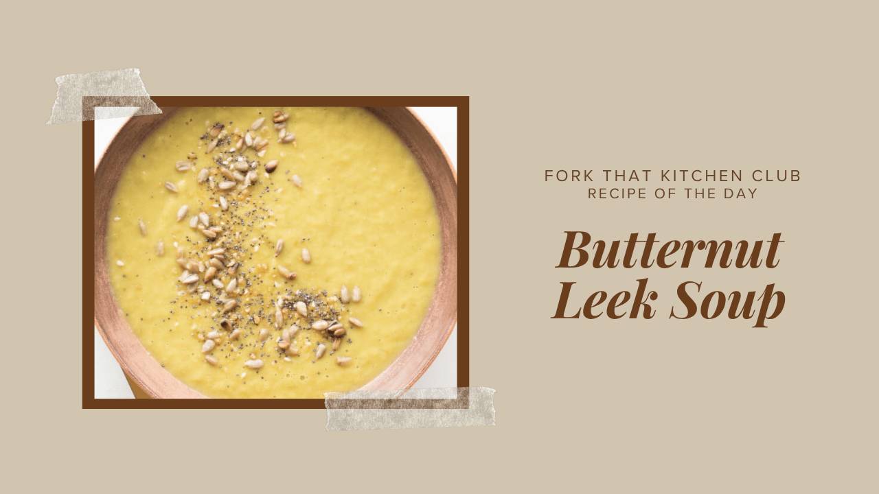Creamy butternut leek soup in a wooden bowl, golden-yellow and smooth in texture, topped with everything bagel seasoning and toasted sunflower seeds. 