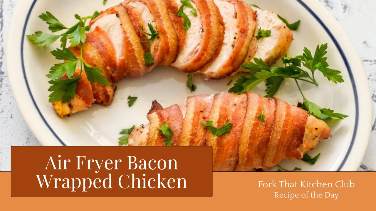 Two sliced, bacon-wrapped chicken breasts on white plate with fresh parsley garnish