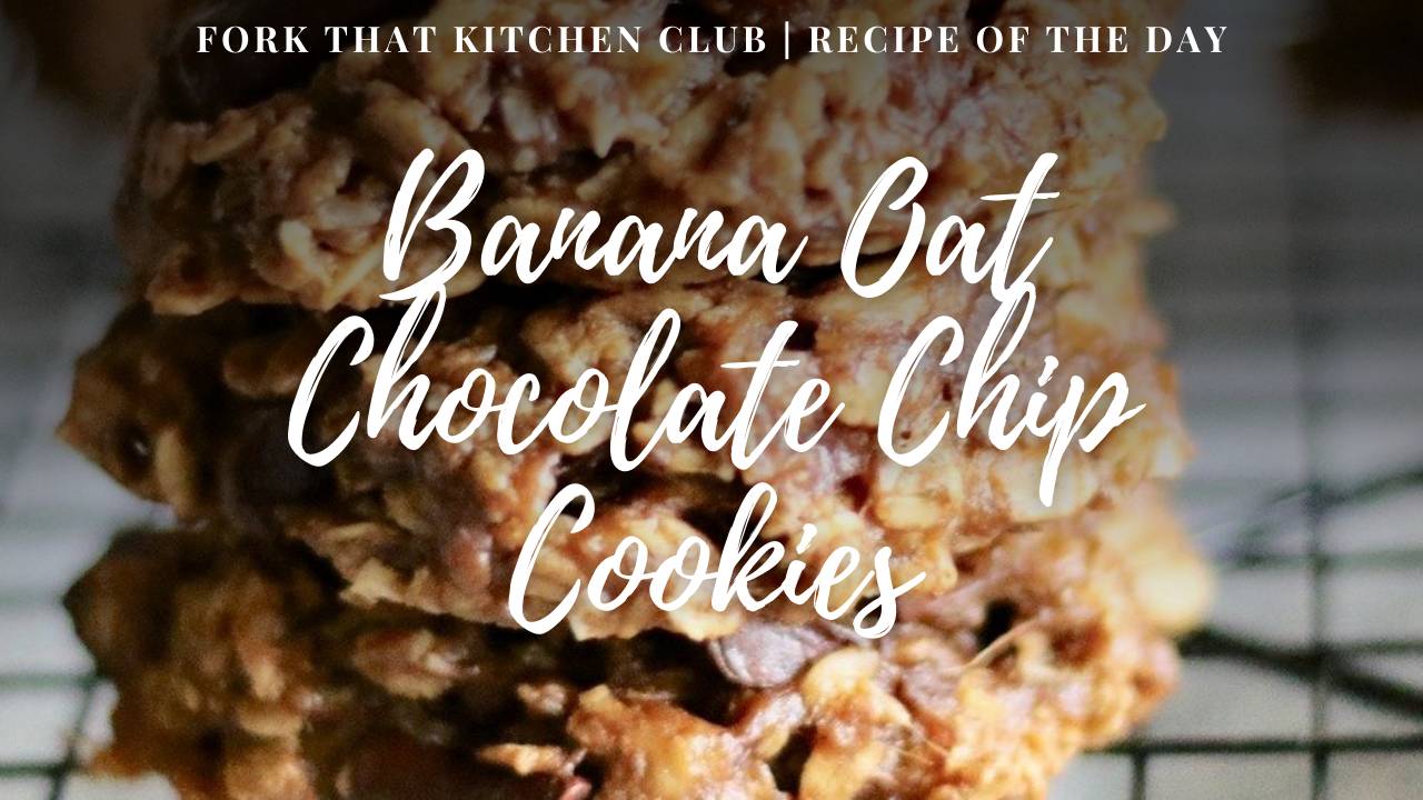 Stack of banana oat chocolate chip cookies with visible oats and chocolate chunks on a black cooling rack