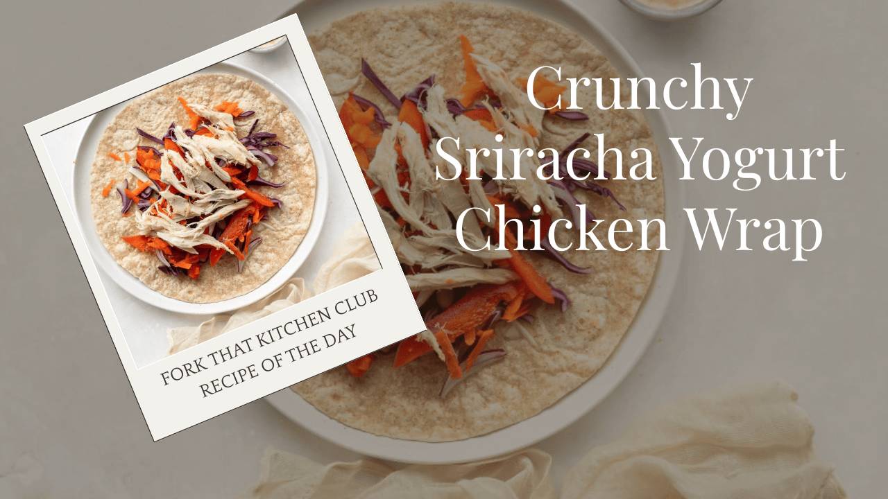 Spelt tortilla wrap filled with shredded chicken, purple cabbage, shredded carrots, and red bell pepper on white plate, creamy sriracha yogurt sauce visible, light wooden surface underneath