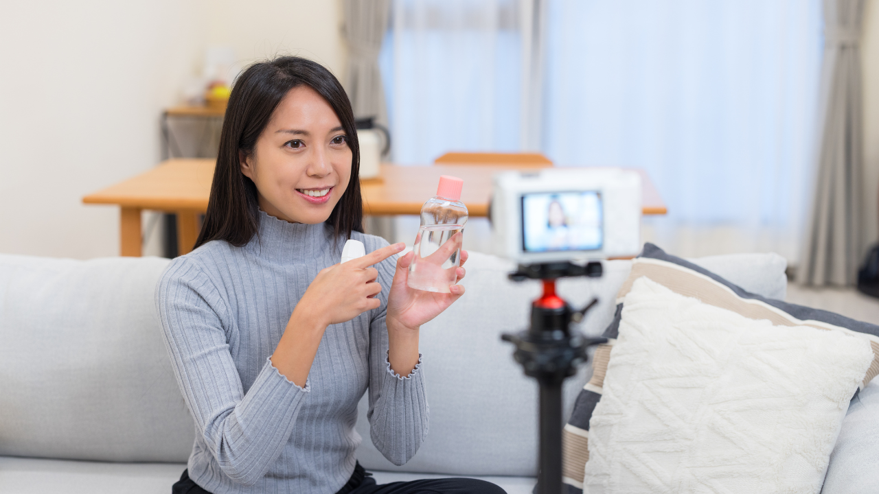 Woman recording video selling beauty product as influencer