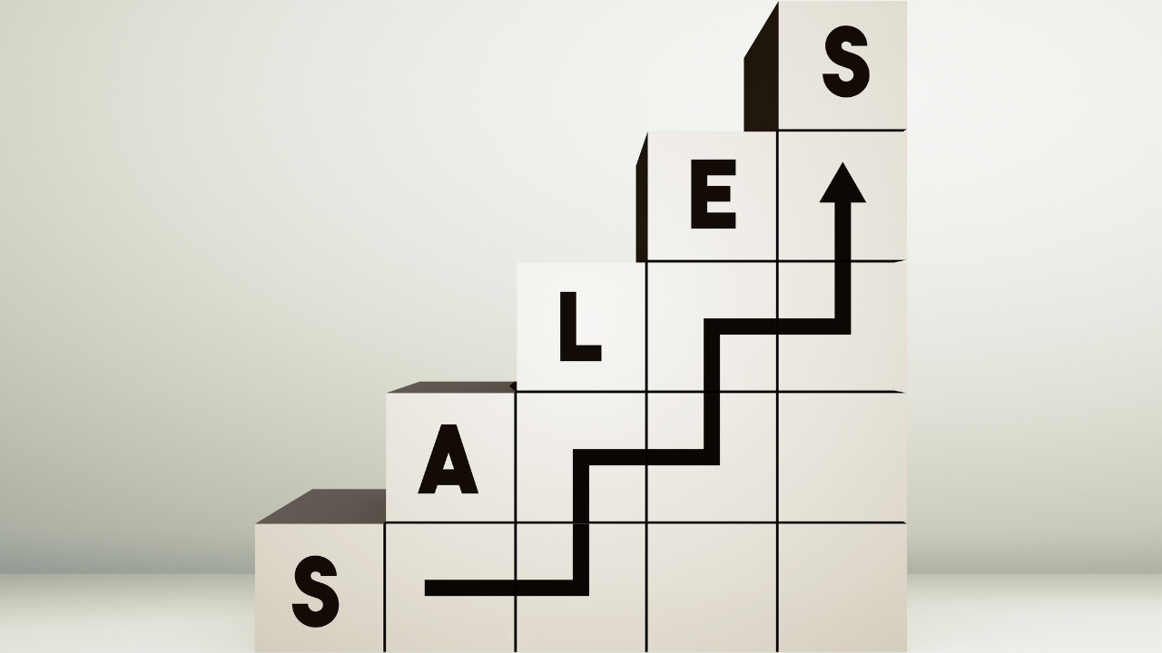 Stair-step blocks spelling “sales” with an arrow showing business growth