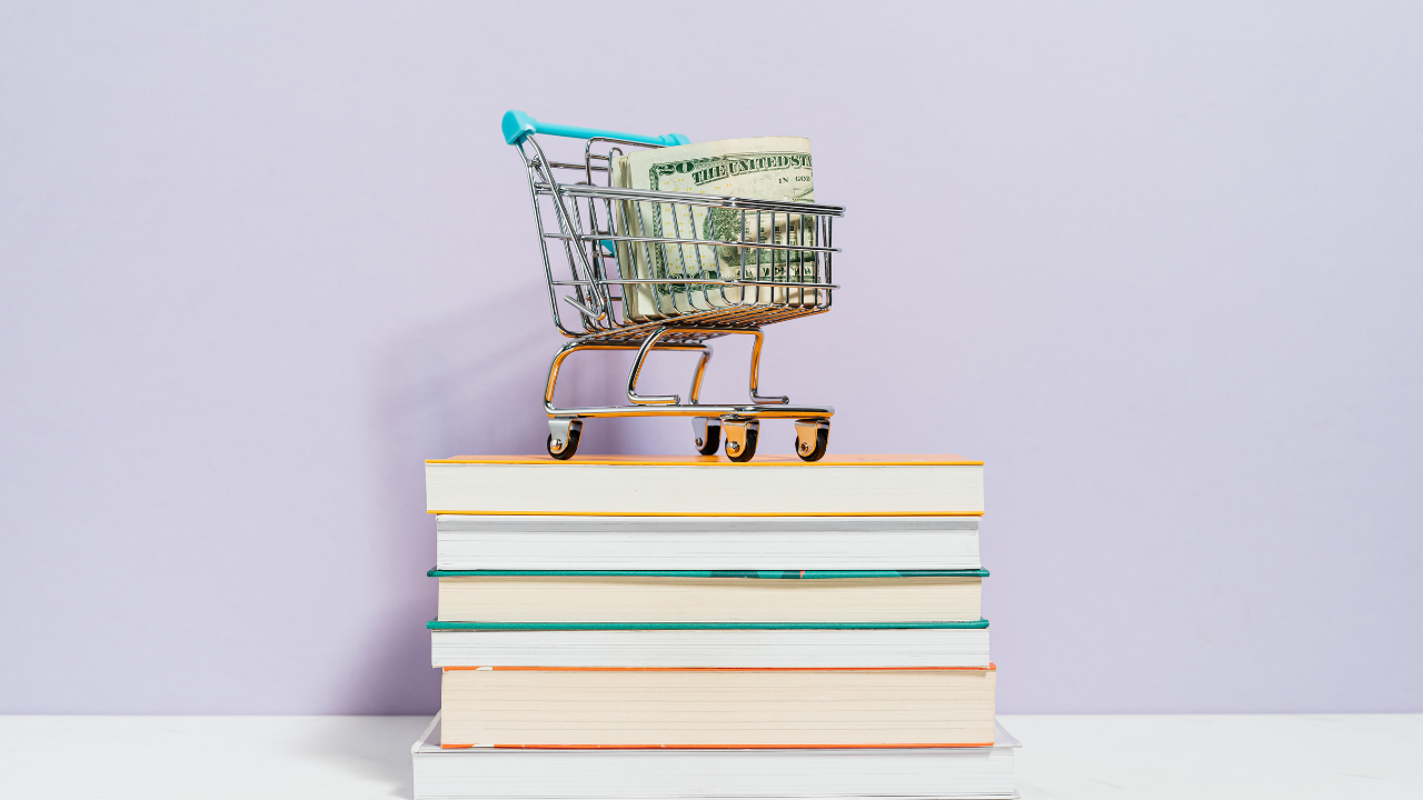 money shopping cart on books