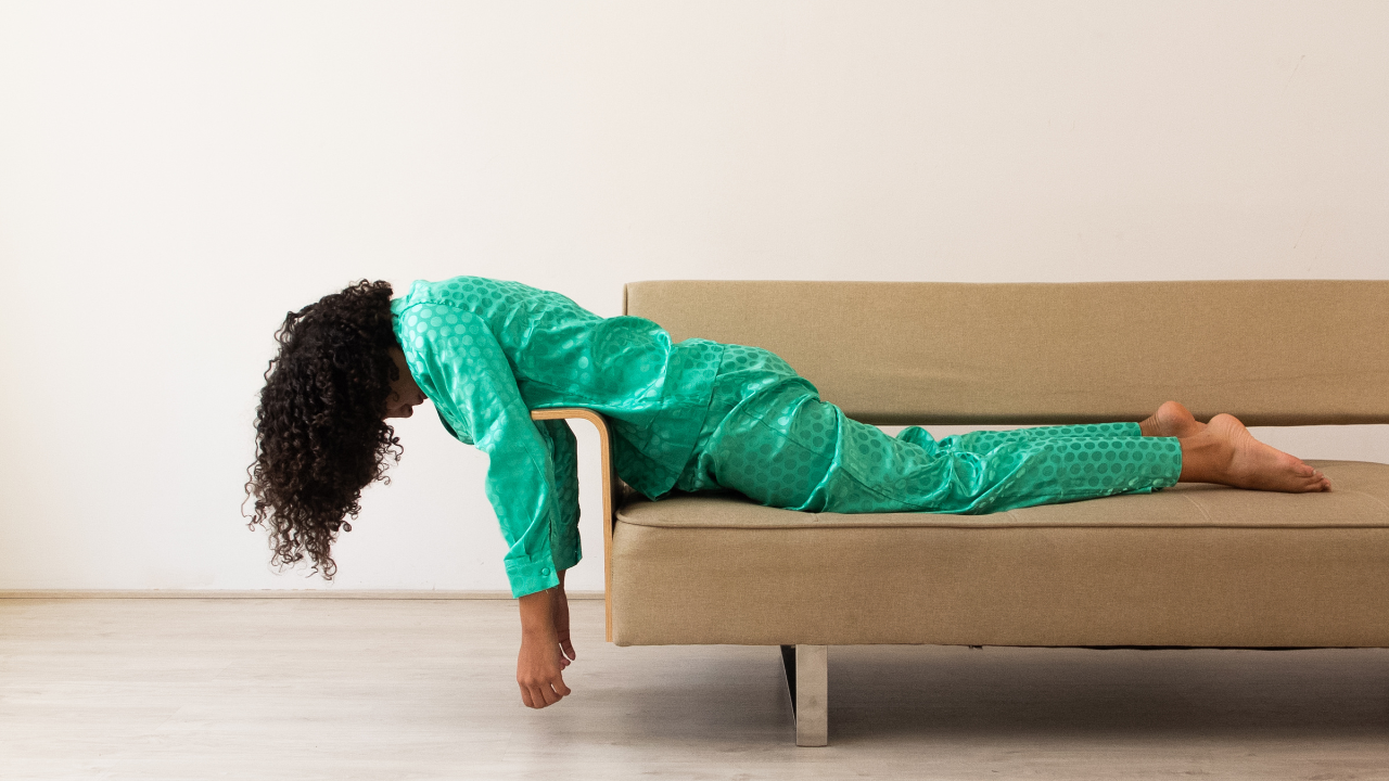 WOMEN LAYING ON COUCH