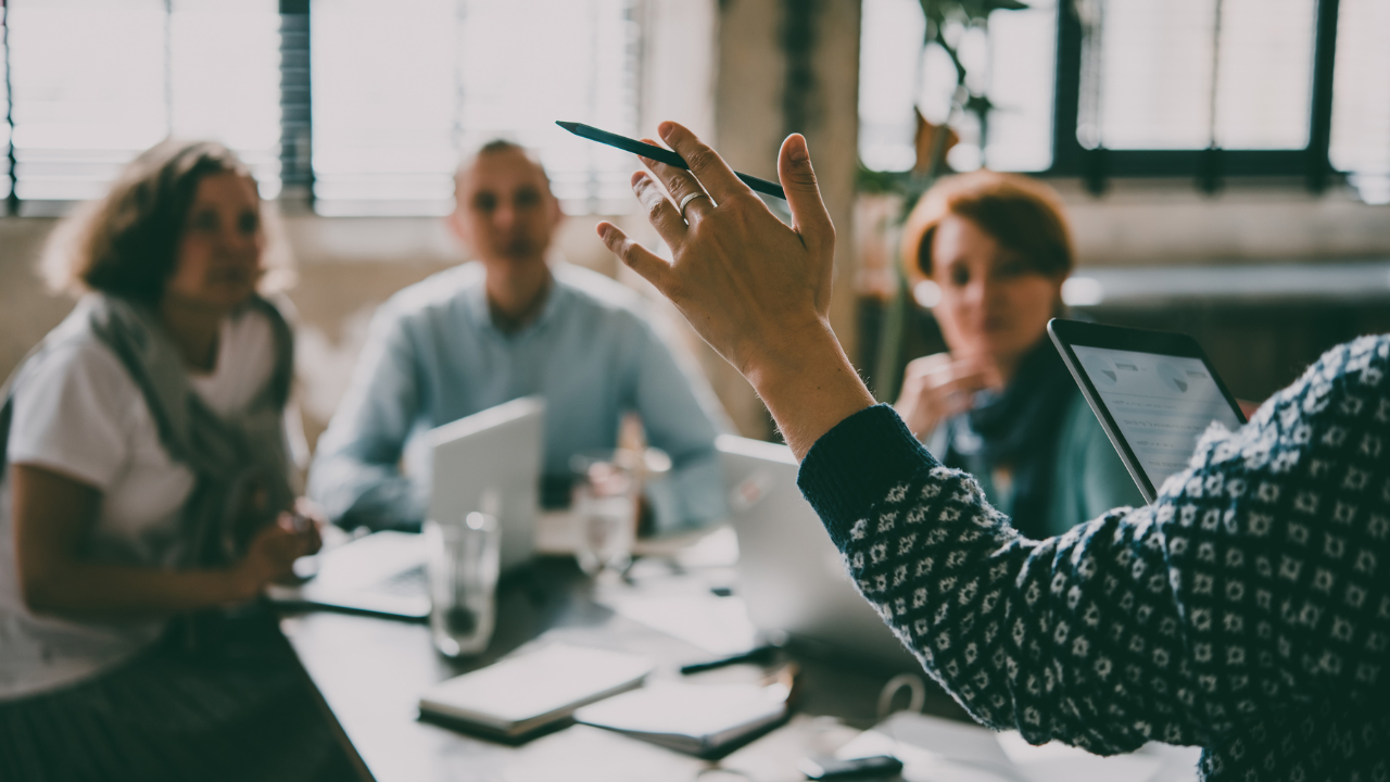 person teaching to 3 other people