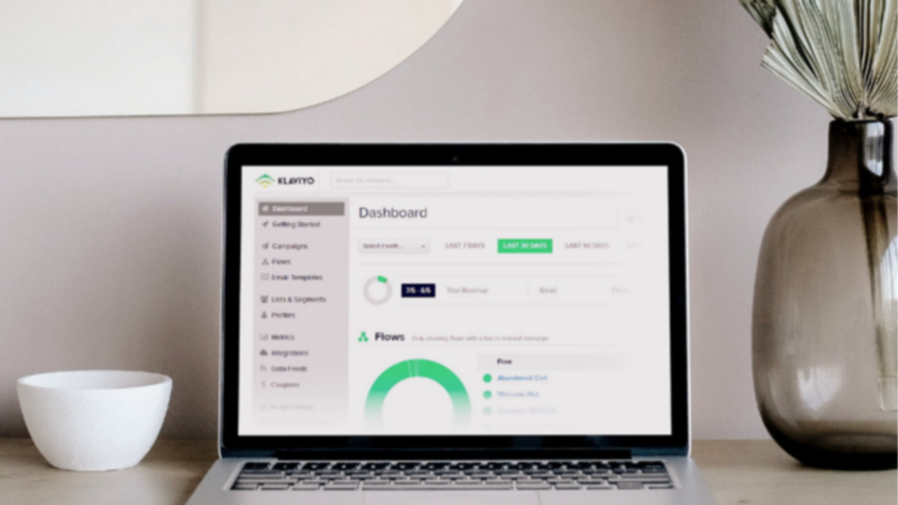 Klaviyo dashboard displayed on laptop showing ecommerce email flows and revenue analytics