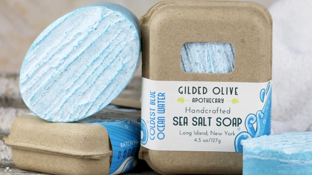 Handcrafted sea salt soap from Gilded Olive Apothecary in Coldest Blue Ocean Water scent, featuring blue textured soap bars in eco-friendly packaging.