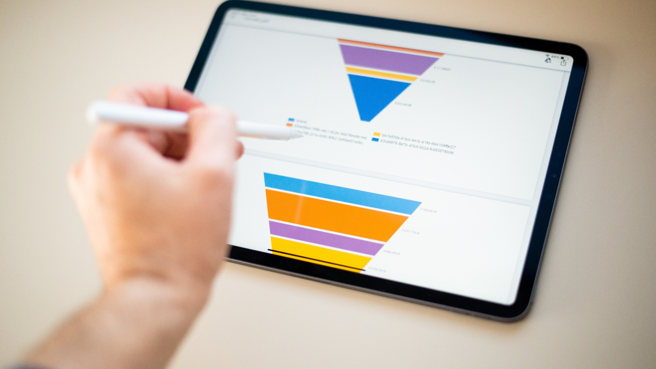 Sales marketing funnel showed on a tablet screen by a young marketer, sales manager pointing data with his pen.