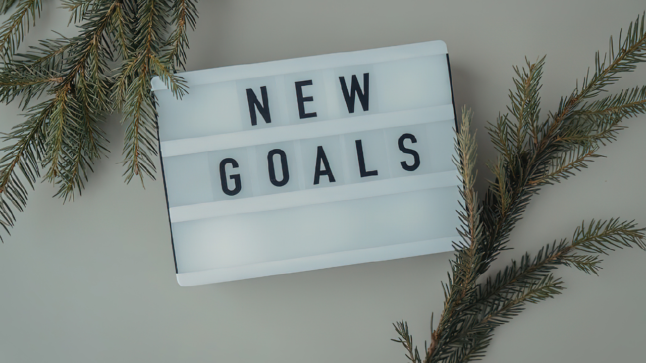 new goals on a sign and plants