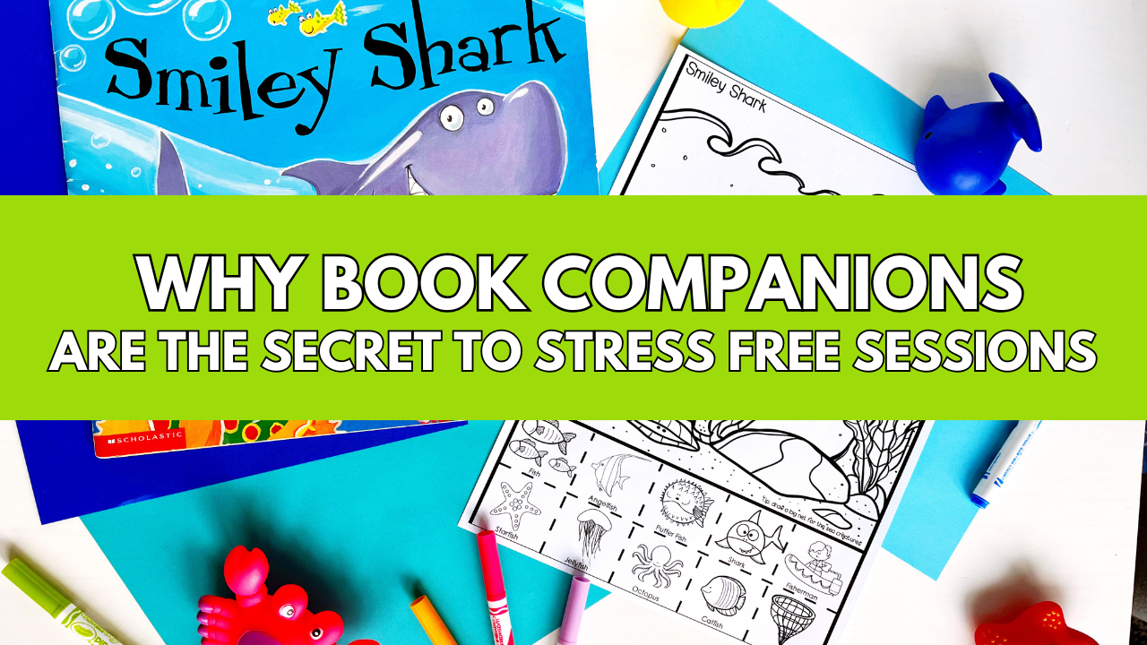 Flat lay of the book Smiley Shark with colorful markers, ocean-themed speech therapy worksheet, and toy sea animals on a bright blue background. Text overlay reads: ‘Why Book Companions Are the Secret to Stress-Free Sessions.