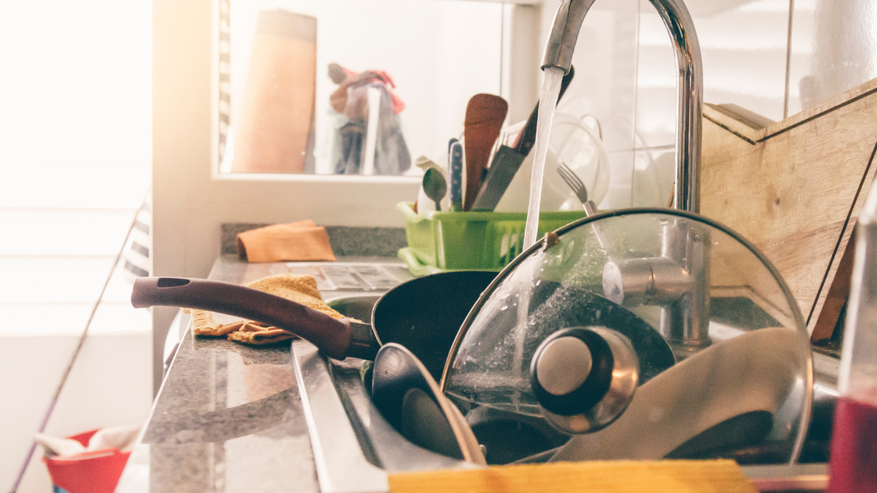 Pile of dirty dishes in sink