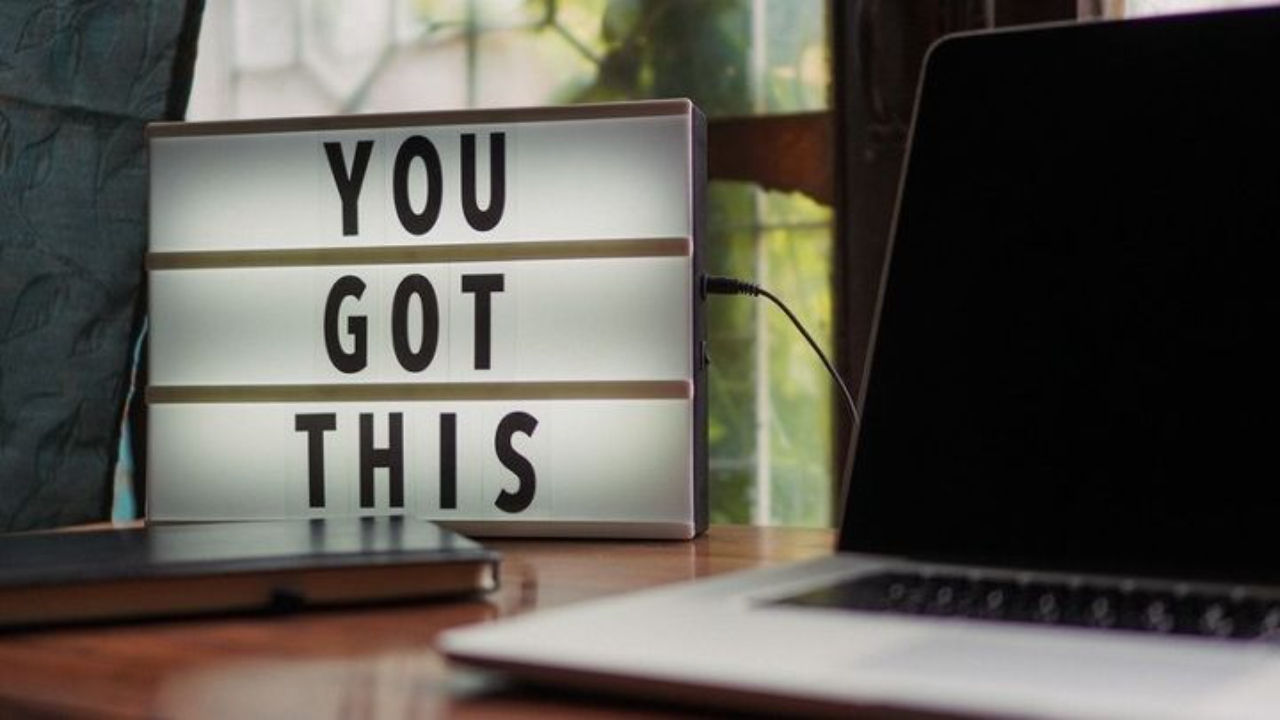 Flat lay of a creative workspace with coffee, notebook, and soft morning light — symbolising new beginnings and taking action.