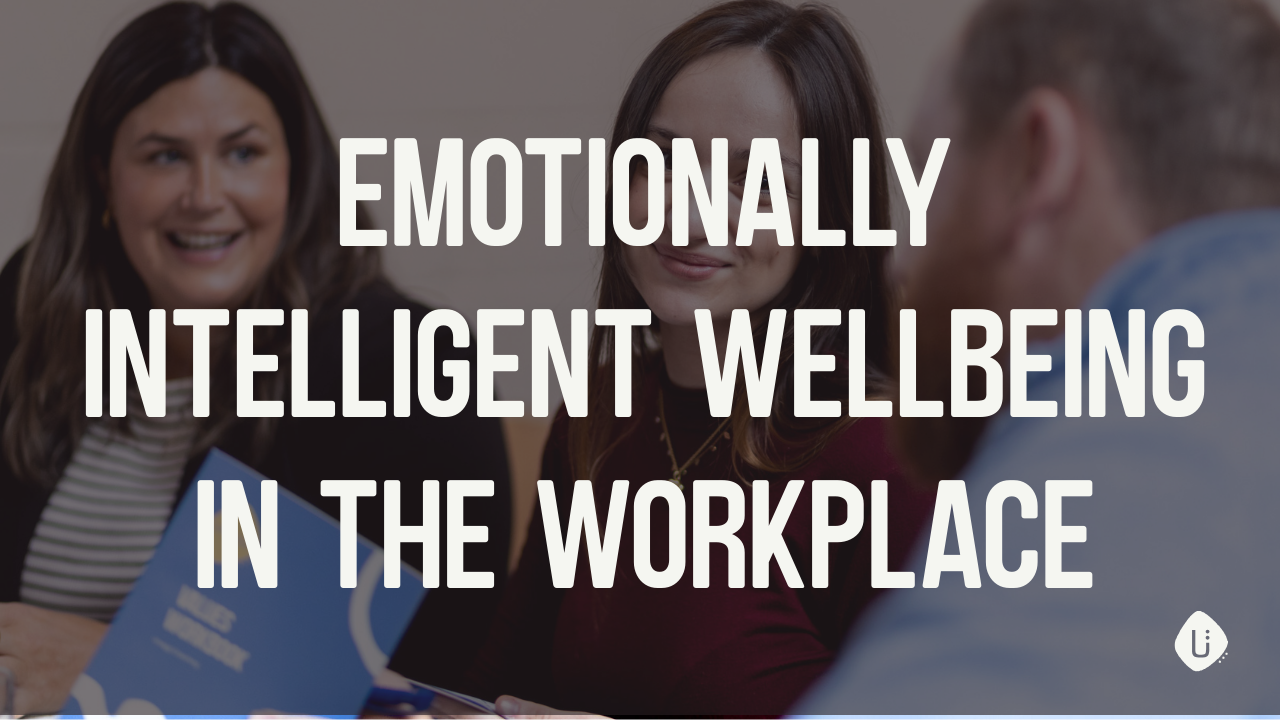 Smiling coworkers enjoying a meeting about emotional intelligence and well-being in the workplace