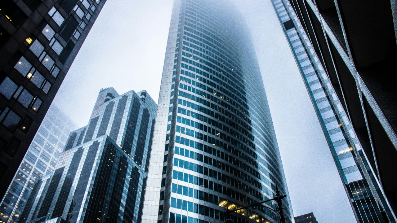 Looking up at modern skyscrapers, representing trends and change in the job market.