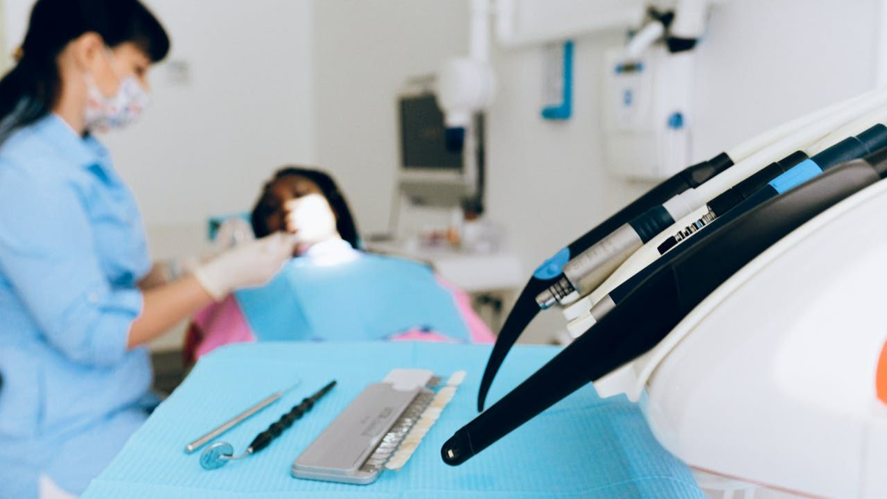 Dentist treating patient in modern dental office demonstrating oral systemic connection to overall health.