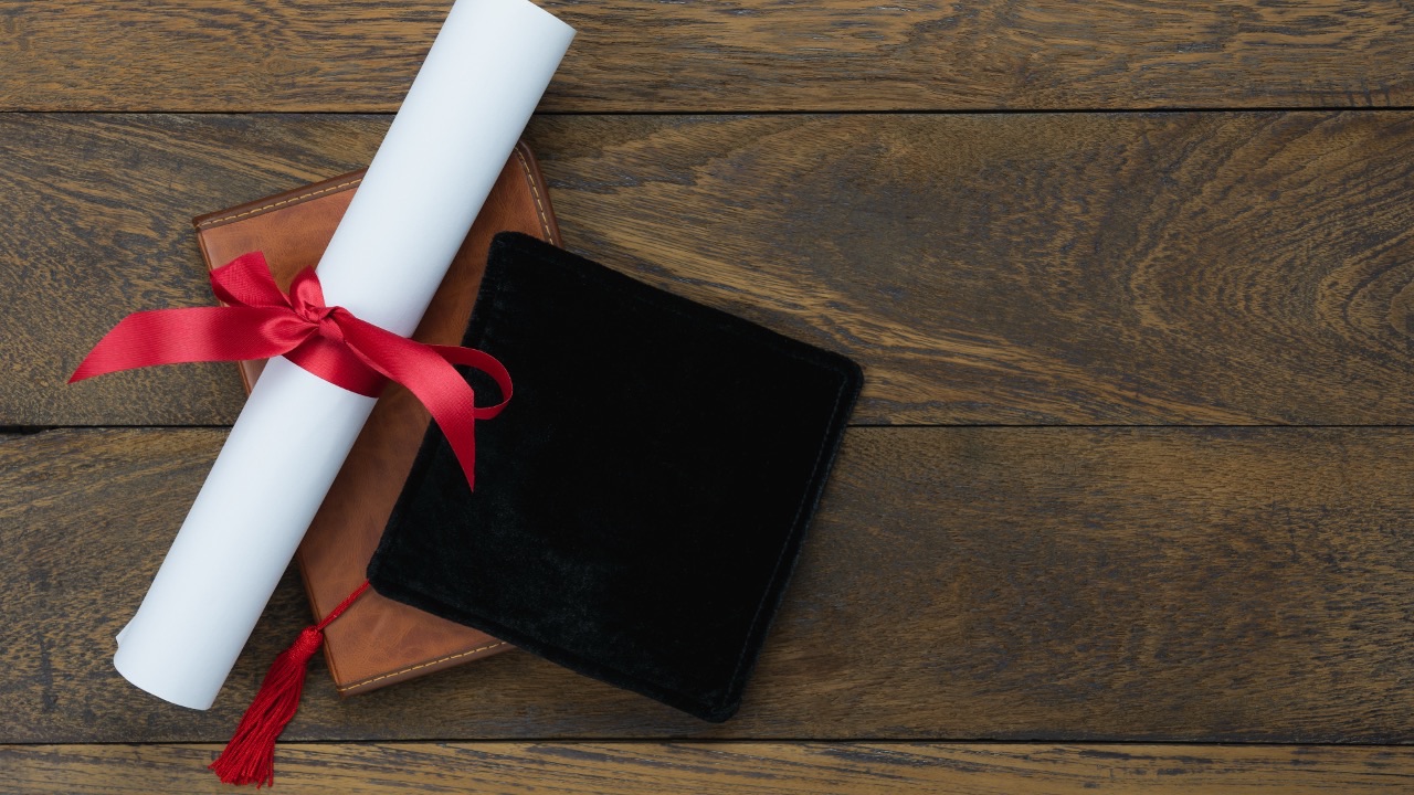 Rolled certificate and diploma case representing accredited qualifications, certification pathways, and professional validation