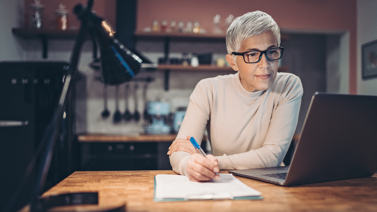 Professional coach working on EMCC accreditation portfolio and reflective practice notes