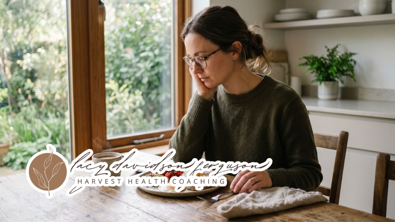 person sitting at a table with a healthy meal looking low energy in soft natural morning light