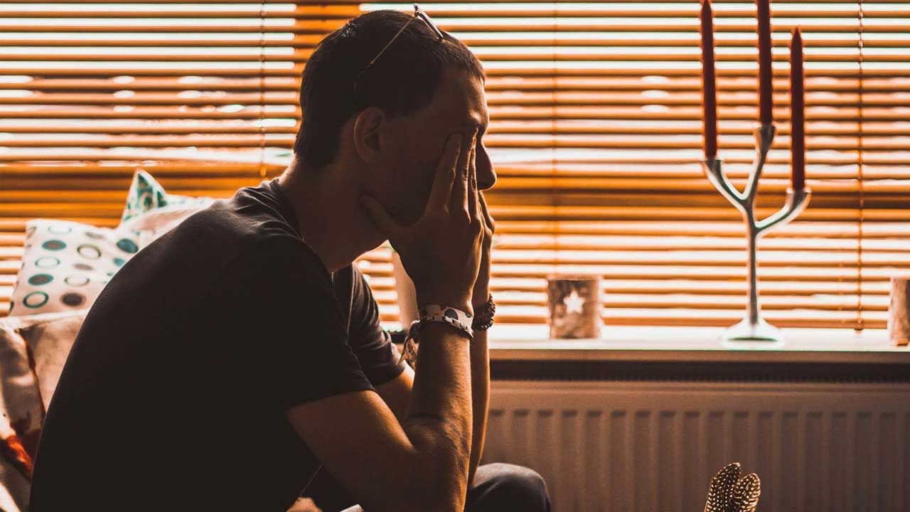man holding his head in his hands