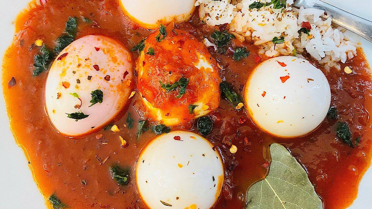 Boiled eggs simmered in deep-browned Cajun tomato gravy.