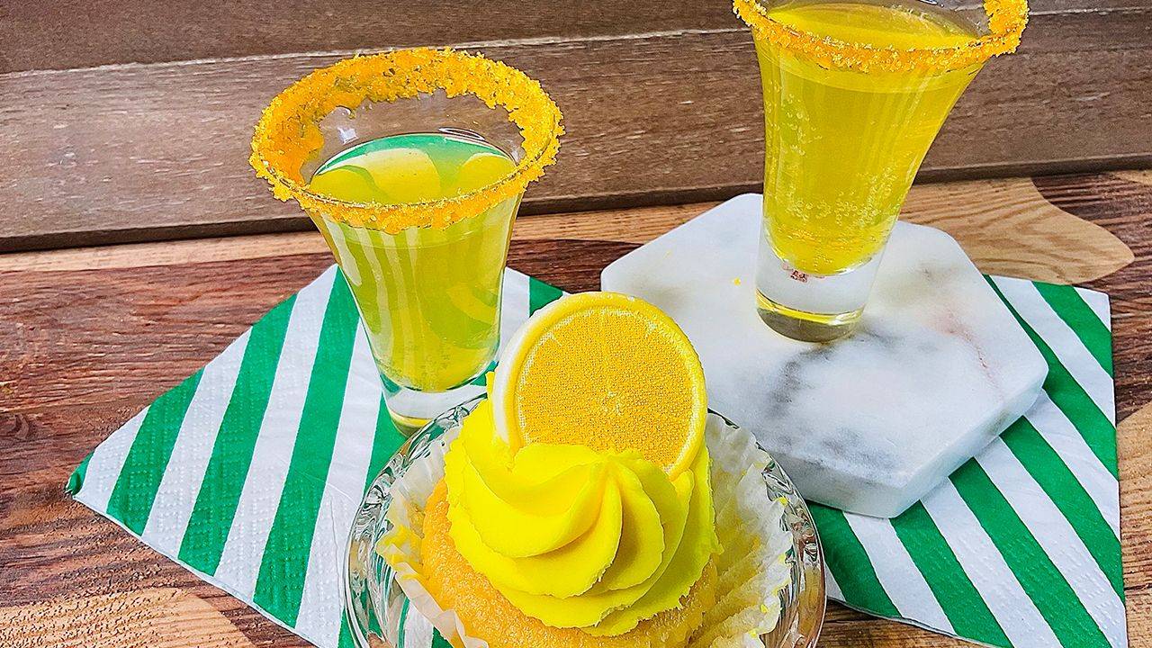 Lemon cupcake dew drop shot with sugar rim and lemon garnish.