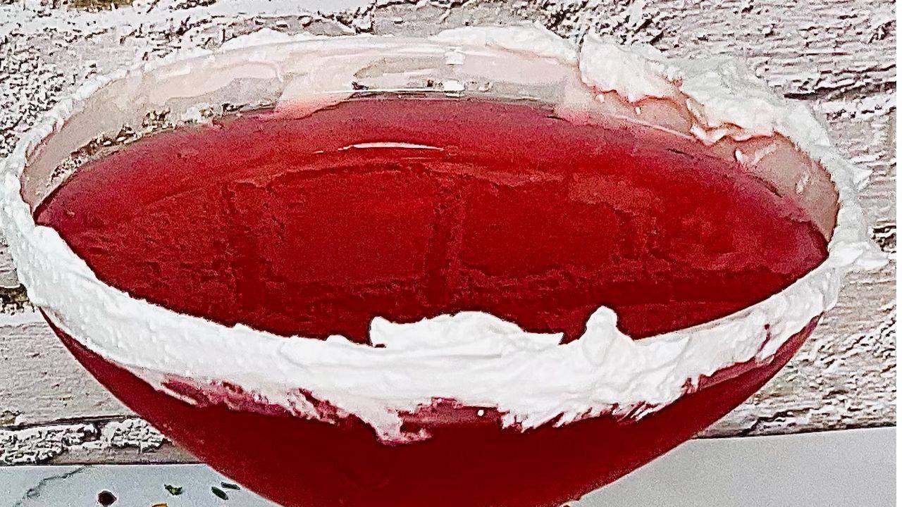 Raspberry misty cream cocktail with cream-rimmed glass and fresh raspberries.