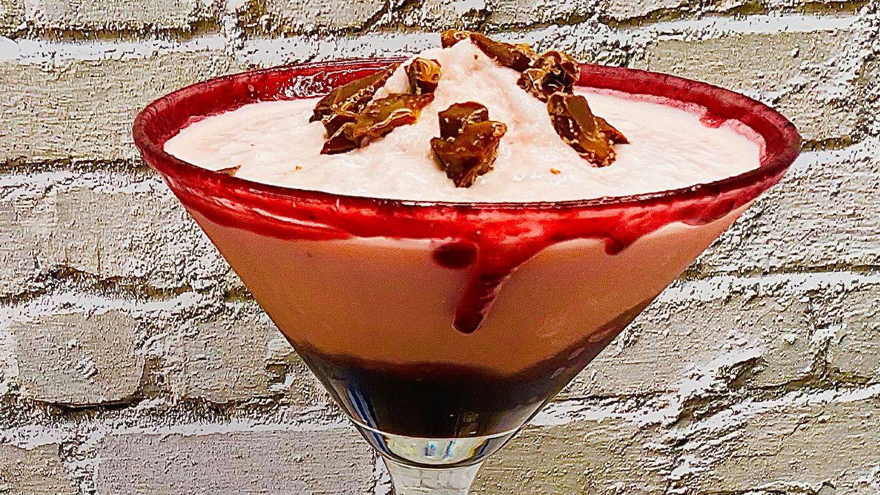 Frozen raspberry chocolate martini with chocolate fudge and raspberry rim.
