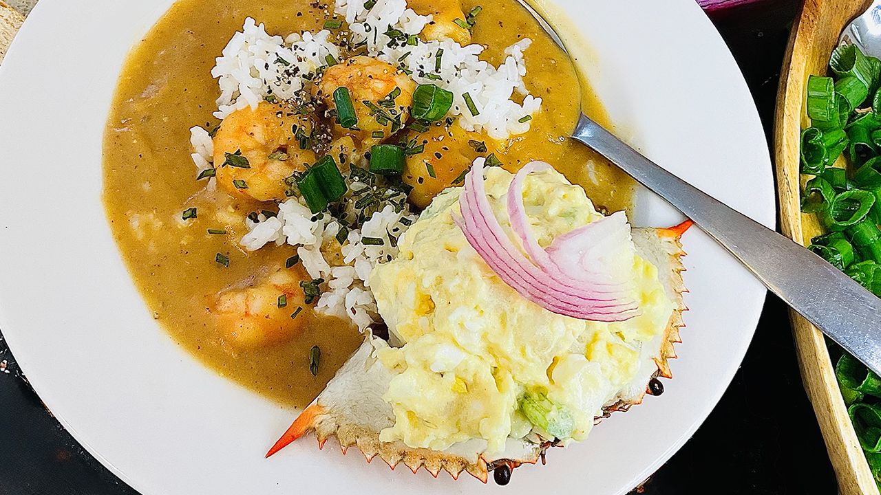Louisiana shrimp creole served over rice with parsley and green onions.