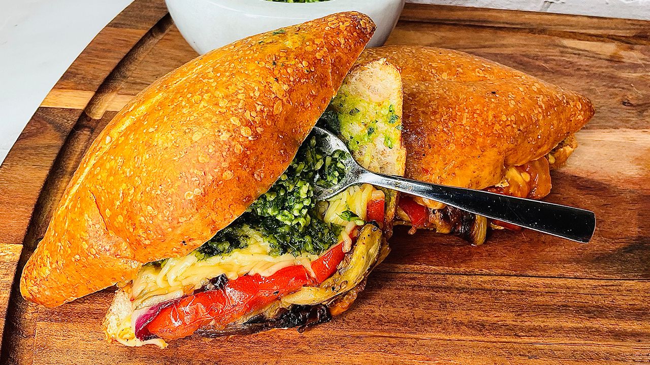 Grilled eggplant and tomato vegetable sandwich with basil parsley pesto.