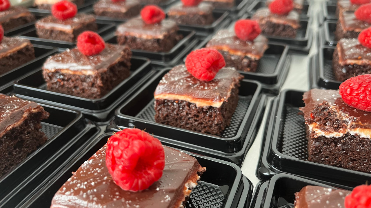 a bakesale with homemade chocolate cake and raspberries made by a home based baker in business