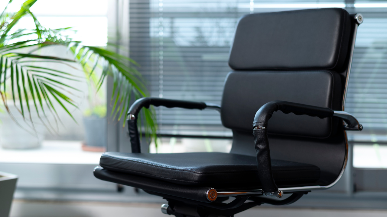 Empty executive chair in a modern office, symbolising absence of leadership or disengagement at the senior level.