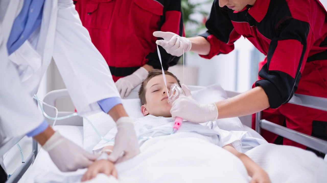 Doctors adjusting oxygen mask while rushing the patient in emergency room to demonstrate how team is operating in chaos