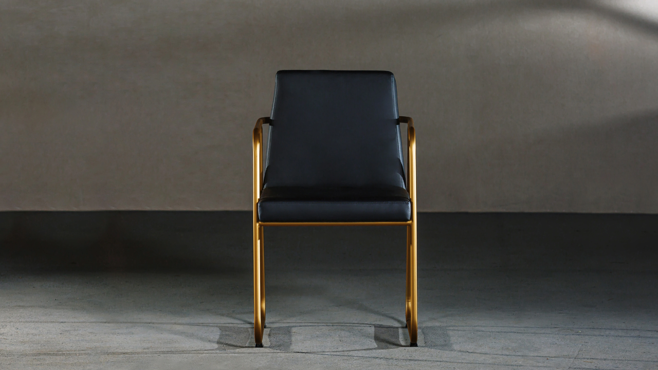 A single chair at the head of a long boardroom table, with empty seats around it, symbolising leadership isolation.