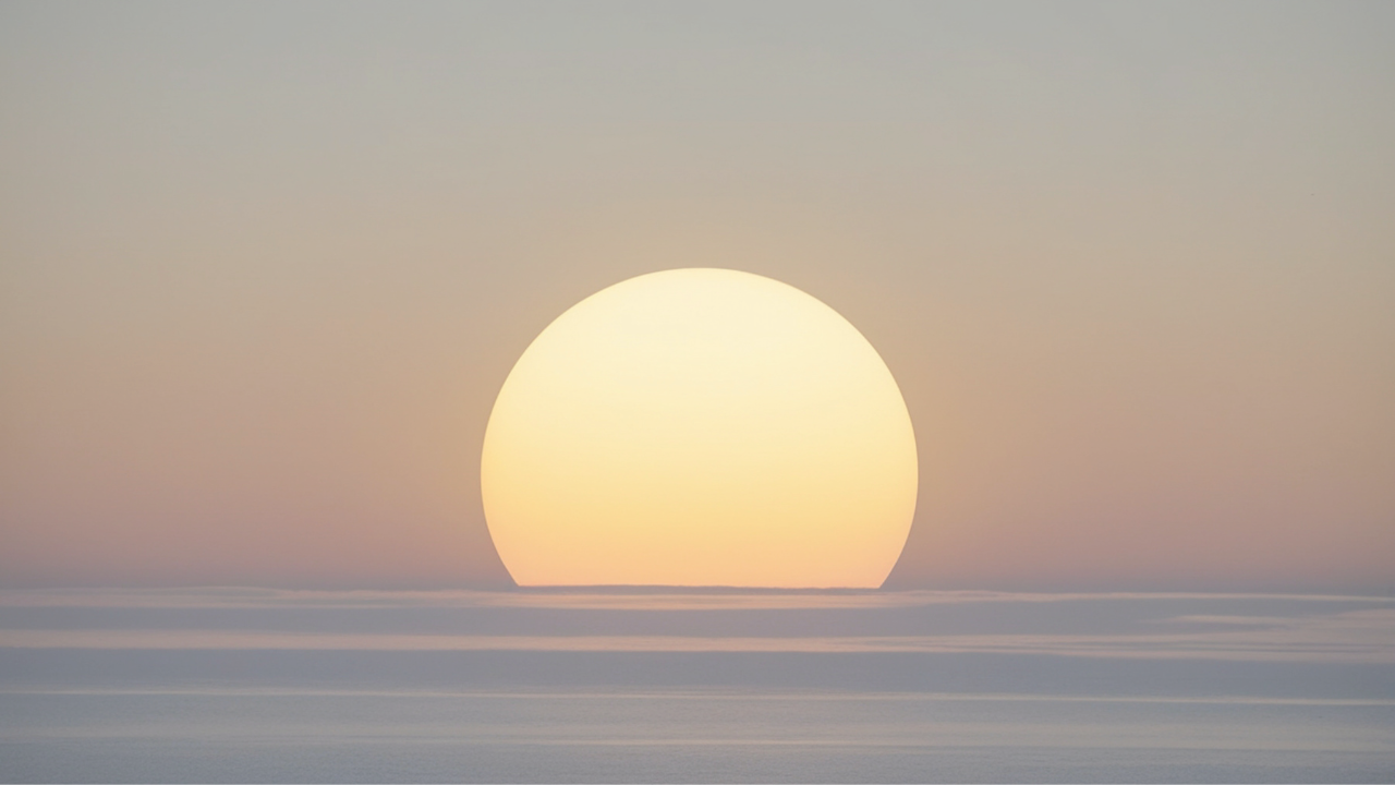 Soft sunrise over calm horizon
