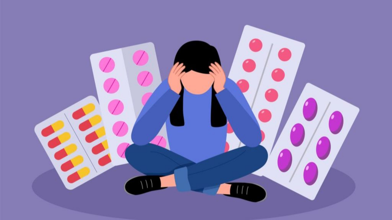 Girl sits amongst pills