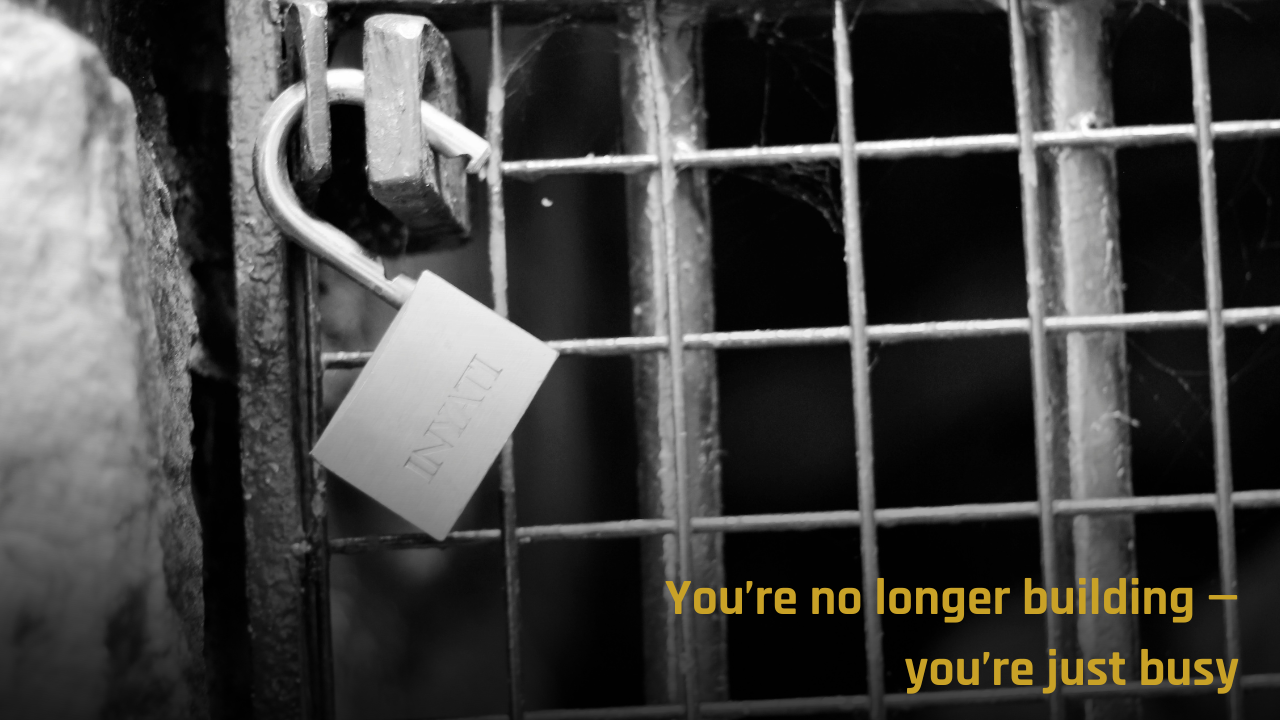 Open padlock on cage symbolizing freedom from chaotic leadership systems.