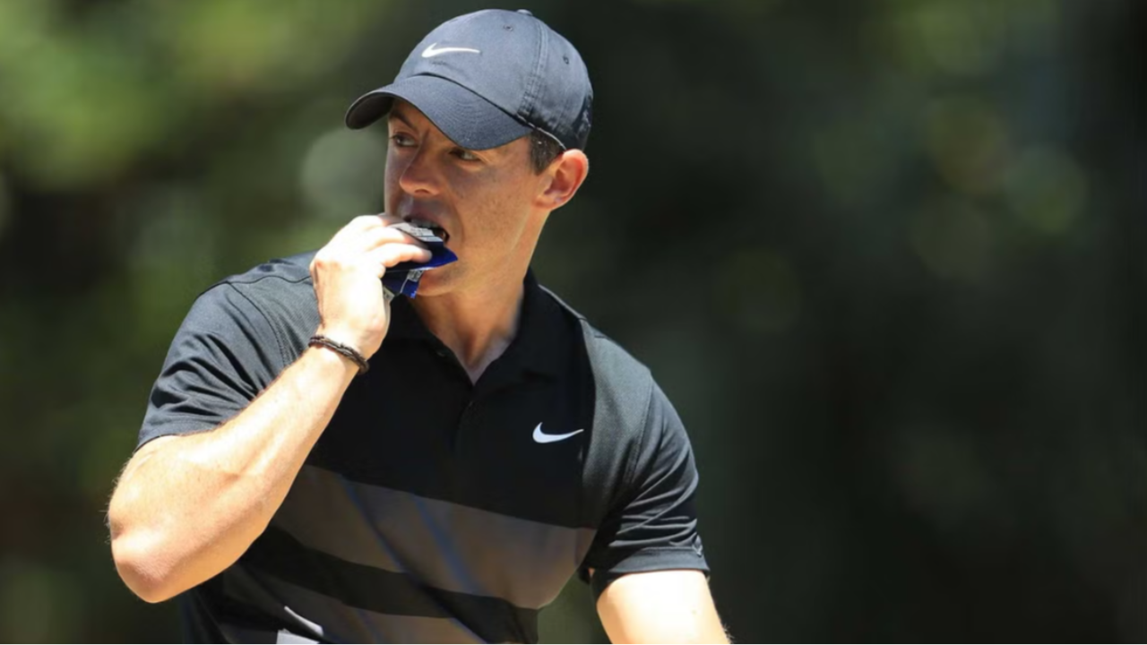Rory McIlroy snacking on a protein bar at the golf course