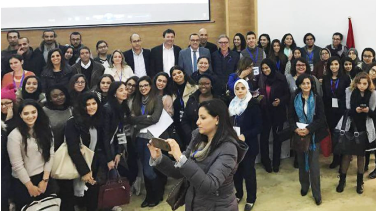 Ines Nasri speaking at the International Scientific Symposium on Marketing Digitalisation in Morocco, discussing digital transformation and brand management.